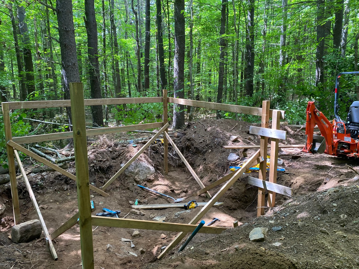 A look back at septic framing taking shape in the woods. Slow, careful work between roots, rocks, and trees before anything could move forwa…