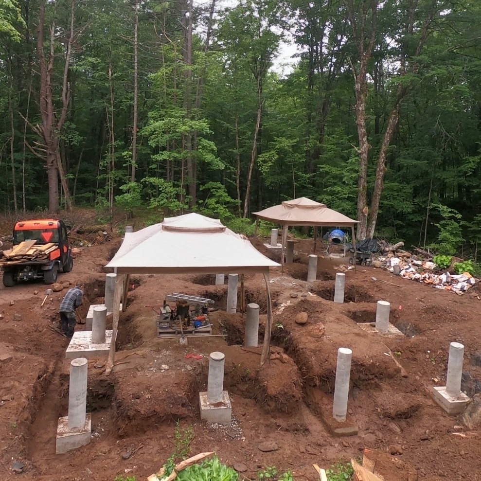 And with a final push, the last concrete footing and pier is poured and stripped. Up next we'll continue to trench between the footings befo…