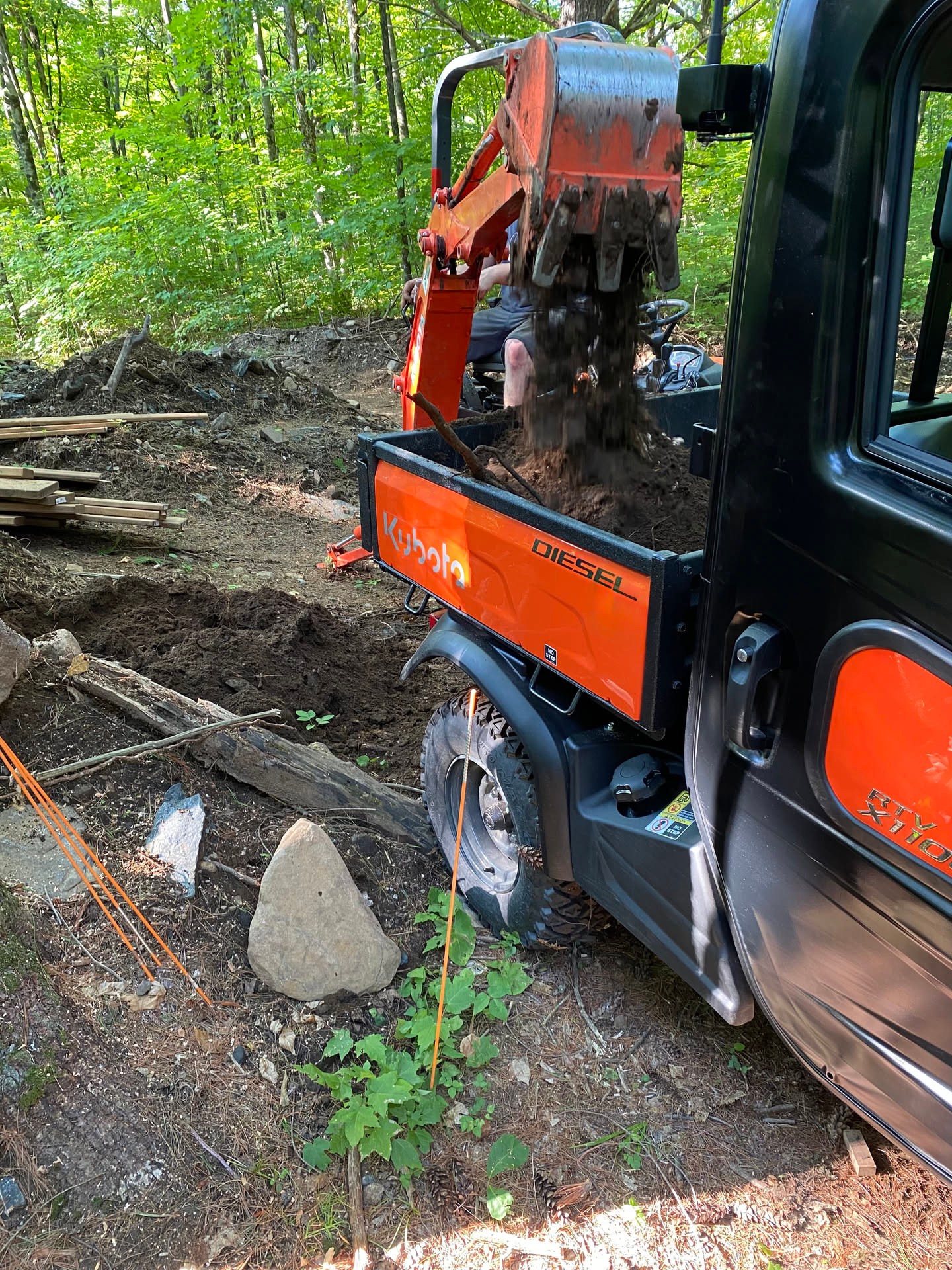 The Kubota RTV and Kubota tractor have an almost symbiotic relationship in the forest. The front loader is the perfect width to fill the bed…