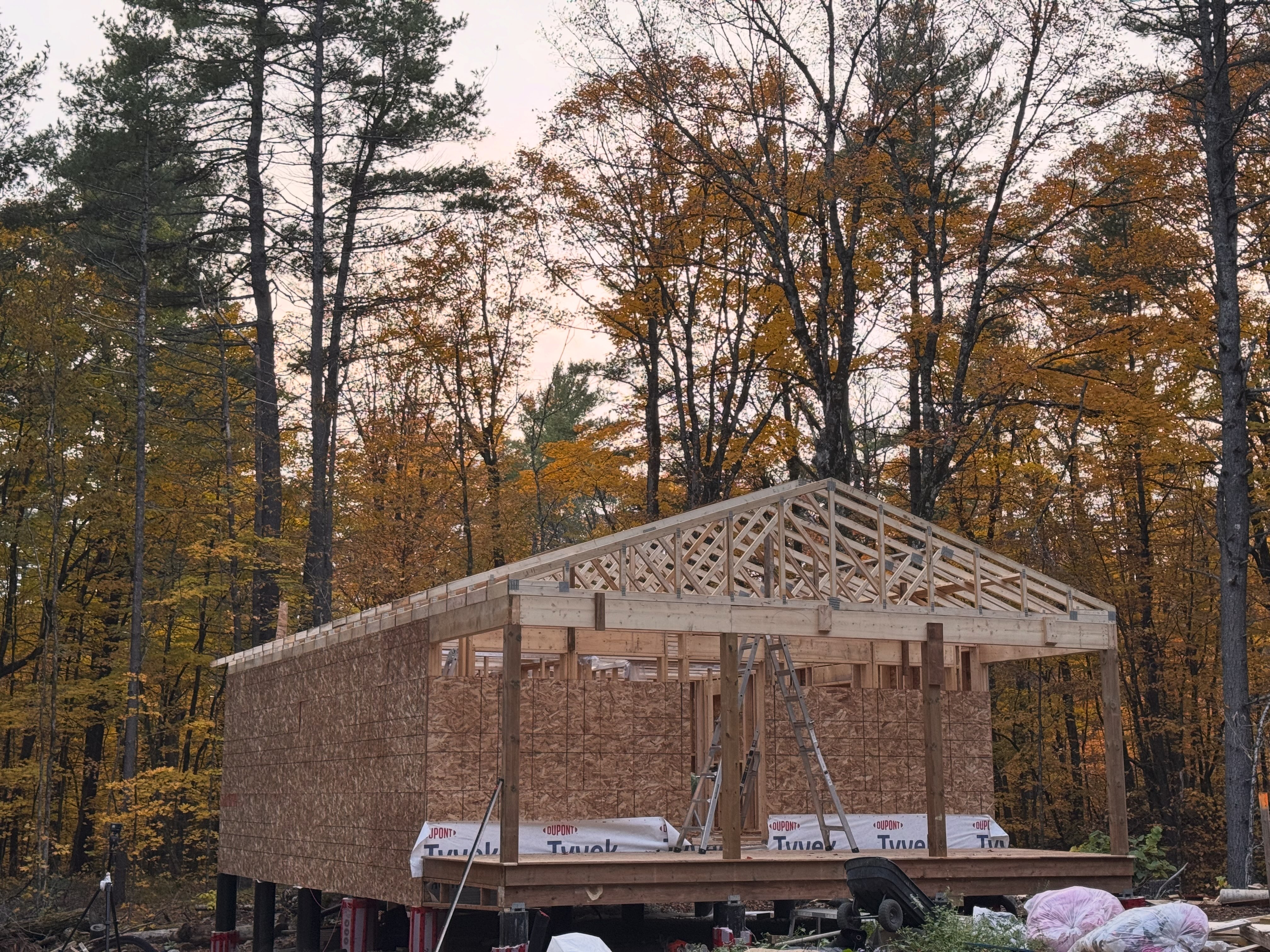 We’ve raised all of the trusses, levelled, and attached them. The front porch deck is also done